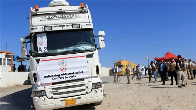 Iraqi trucks loaded with humanitarian aid head to Syria