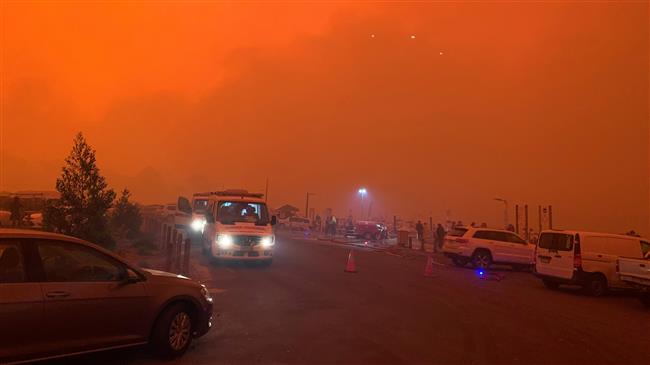 Australian authorities steer mass evacuation as wildfires raze holiday towns