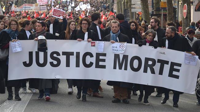 French lawyers throw their robes onto courthouse steps