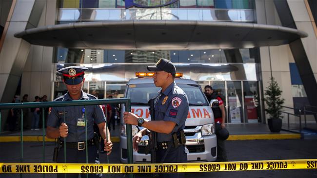 Gunman shoots 1, holding dozens hostage in Philippines