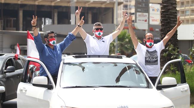 Lebanon protesters back on streets in cars amid virus outbreak