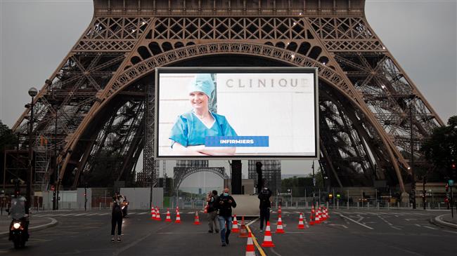 Eiffel Tower screens portraits of front-line workers in tribute