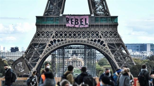 Extinction Rebellion unfurls 'Rebel' banner on Eiffel Tower