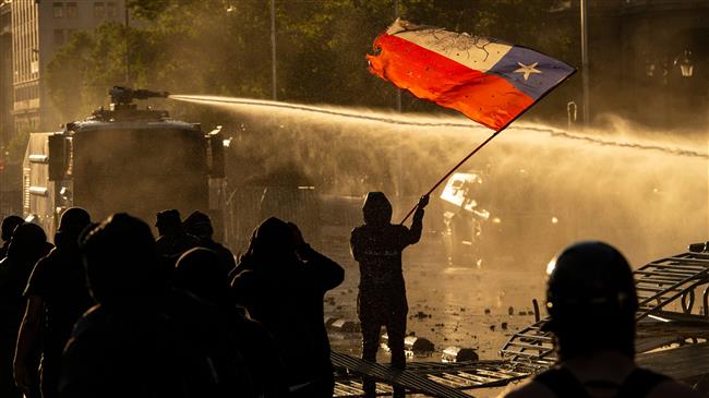 Riot police, water cannon in force as protesters march in Chile
