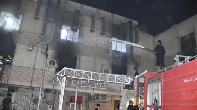Patients carried from Baghdad hospital after fire kills 27